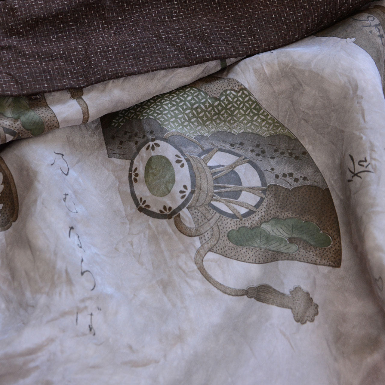Close-up of haori lining — printed fan and drum motifs with Kuroda Bushi lyrics, white ground, vintage Japanese haori jacket
