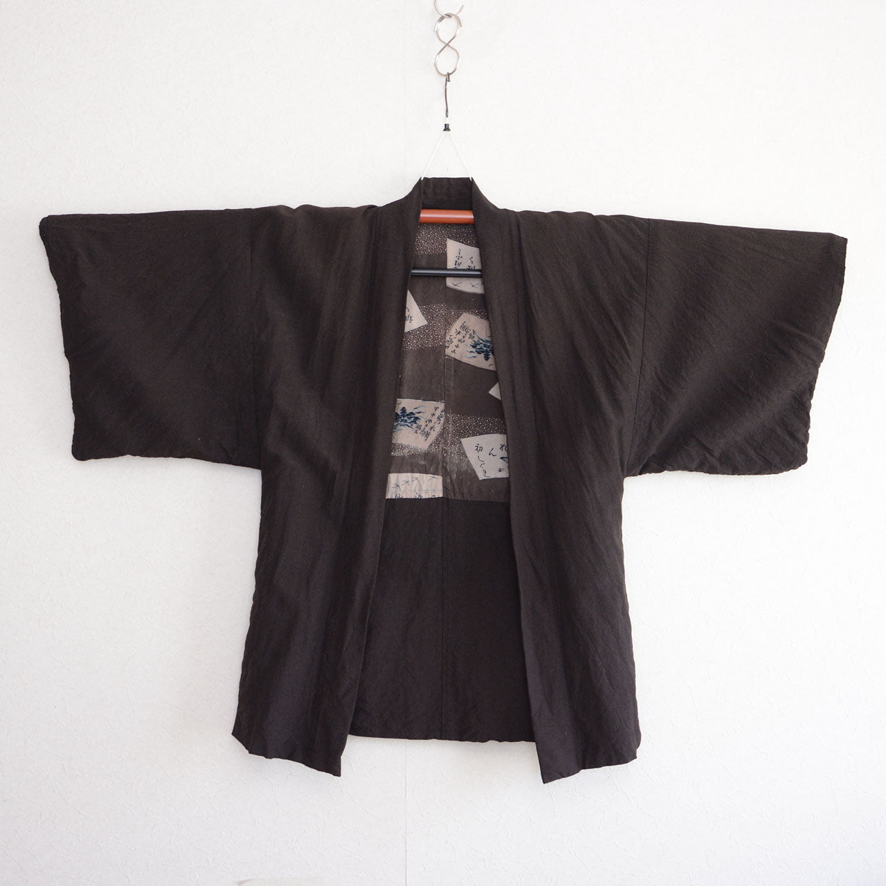 Men's haori jacket, rayon blend, sansui calligraphy lining, Showa era Japan vintage, front view on kimono hanger