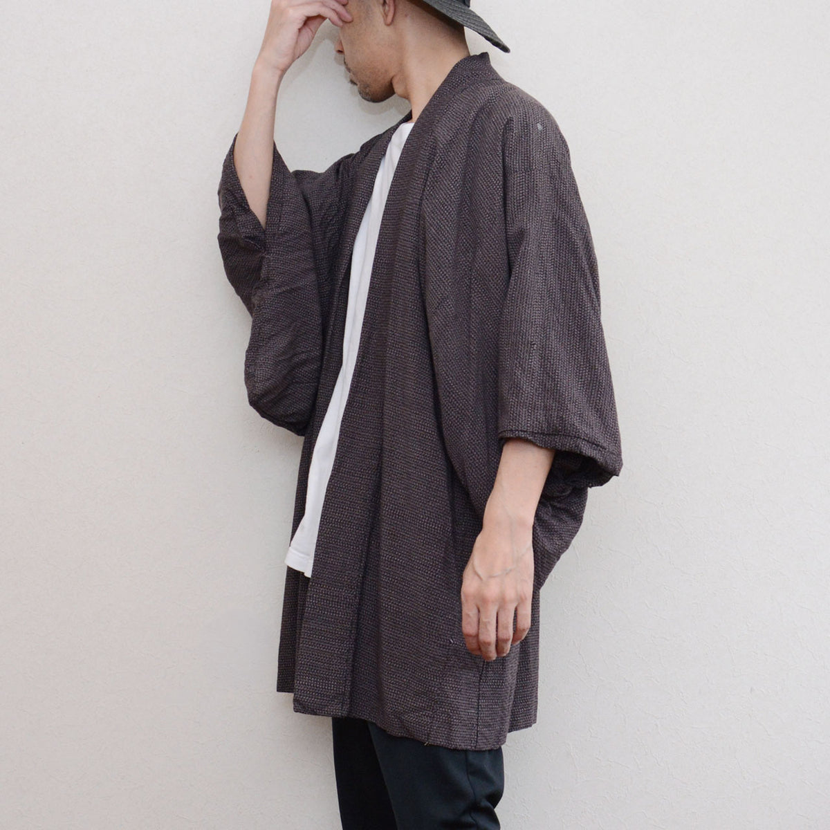 Japanese vintage men's haori worn by a model, side view with hand on head, late Showa era