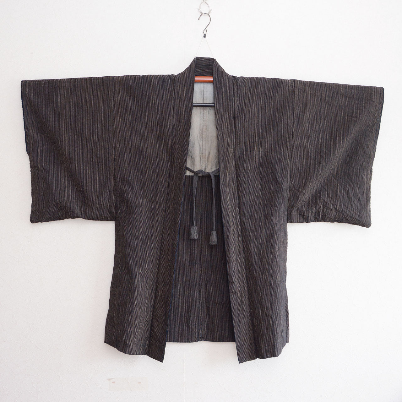 Front view of a men's vintage Japanese indigo striped cotton haori jacket with cord