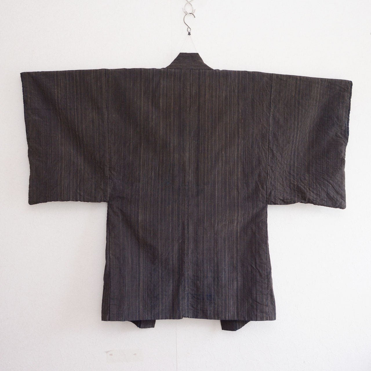 Back view of a men's vintage Japanese indigo striped cotton haori jacket