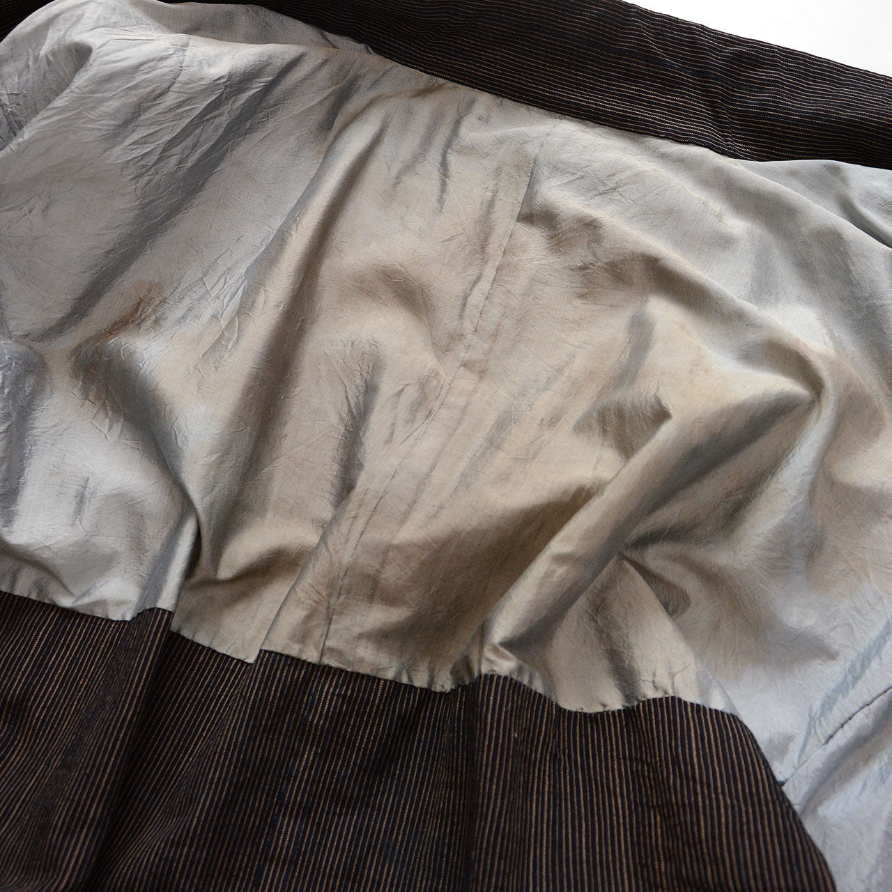 Stains and discoloration on the light gray lining of a vintage Japanese haori jacket