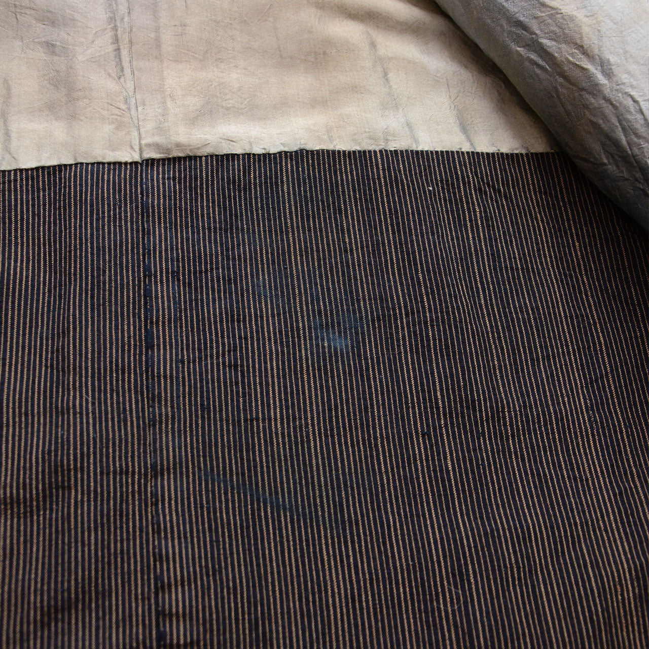 Light gray lining beside the indigo striped cotton outer fabric of a vintage haori jacket
