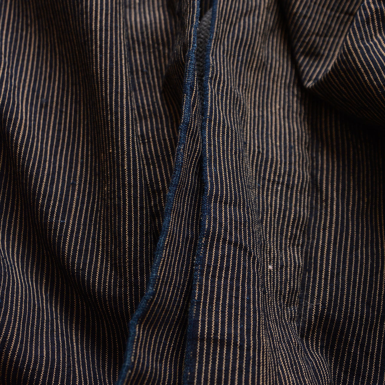 Frayed front edge revealing brighter indigo on a men's vintage Japanese cotton haori