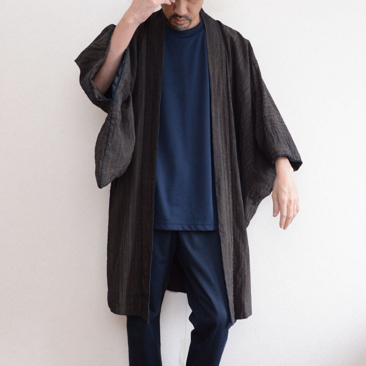 171 cm male model wearing a vintage Japanese indigo striped cotton haori from the front