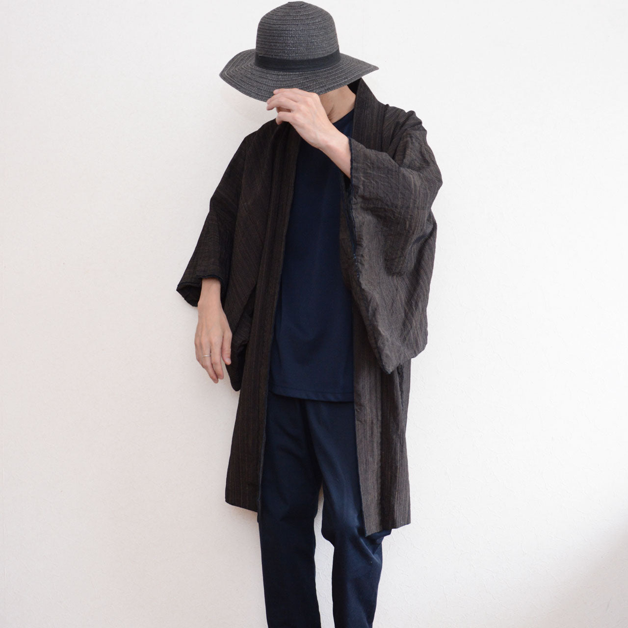 Male model styling a vintage Japanese indigo striped cotton haori with modern navy clothing