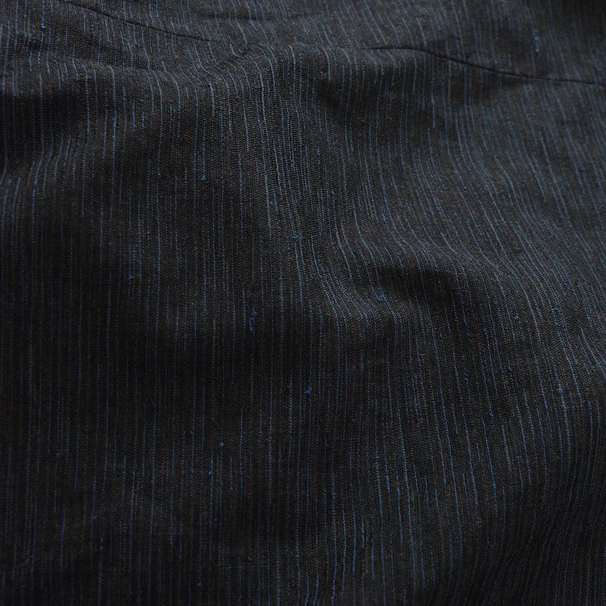 Fine vertical slub texture of the weave on a men's vintage haori jacket, deep subdued tone, 1970s-1980s Japan