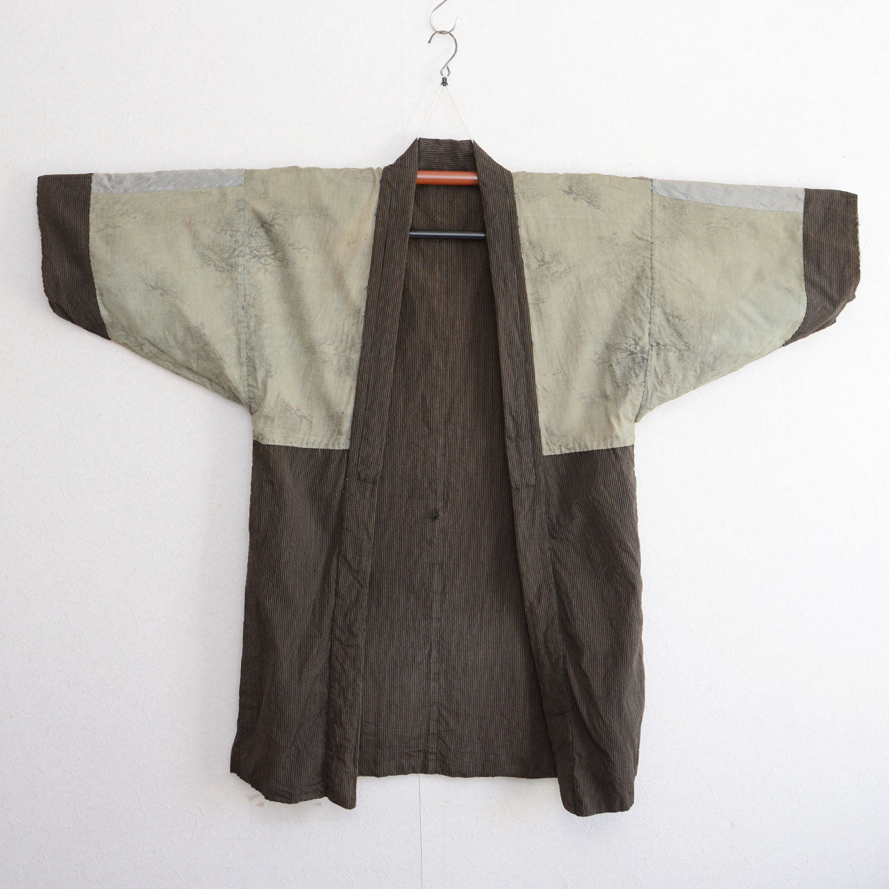 Faded lining of a Japanese vintage haori jacket with a peacock design