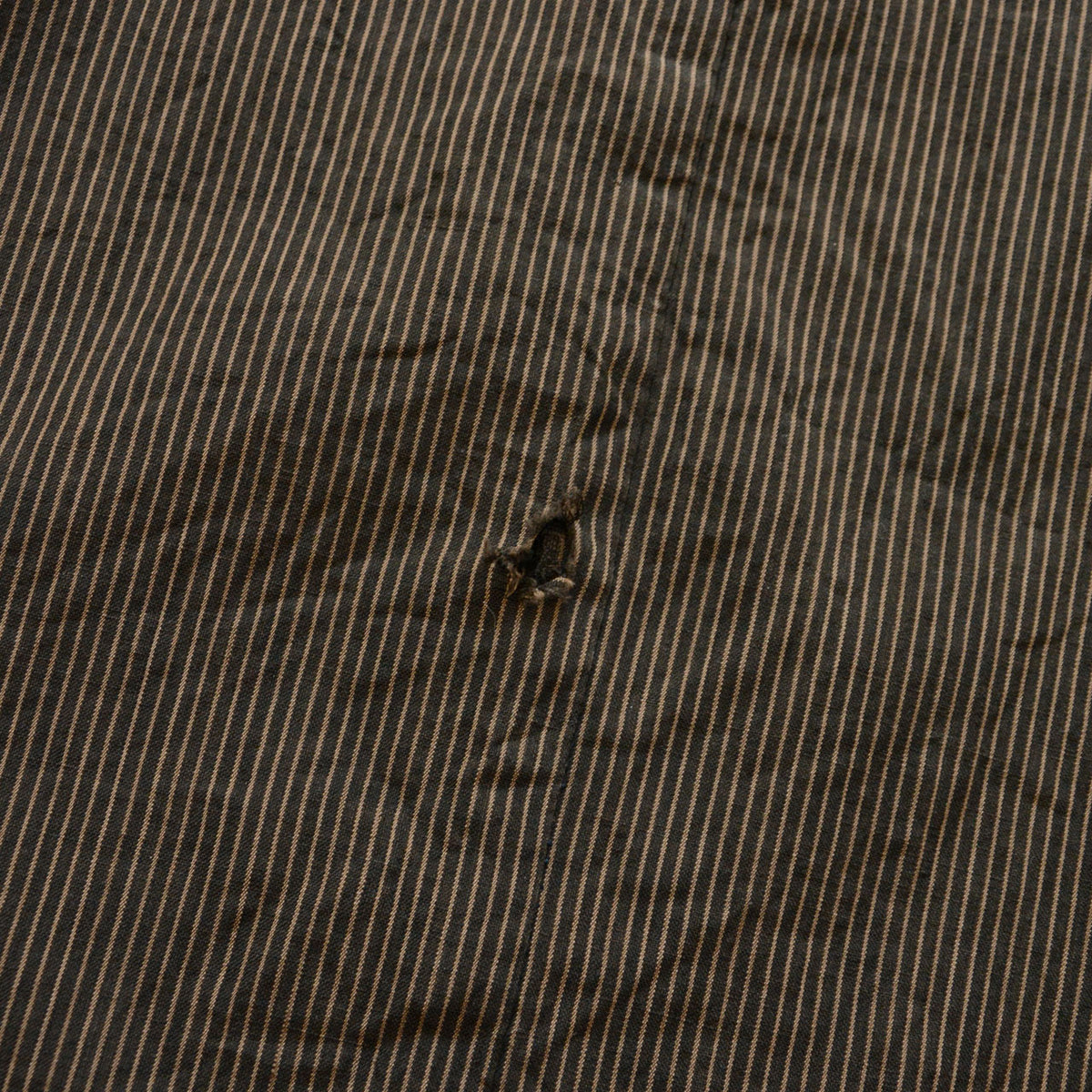 Striped cotton outer fabric of a Japanese vintage haori jacket with abrasion and missing stitches