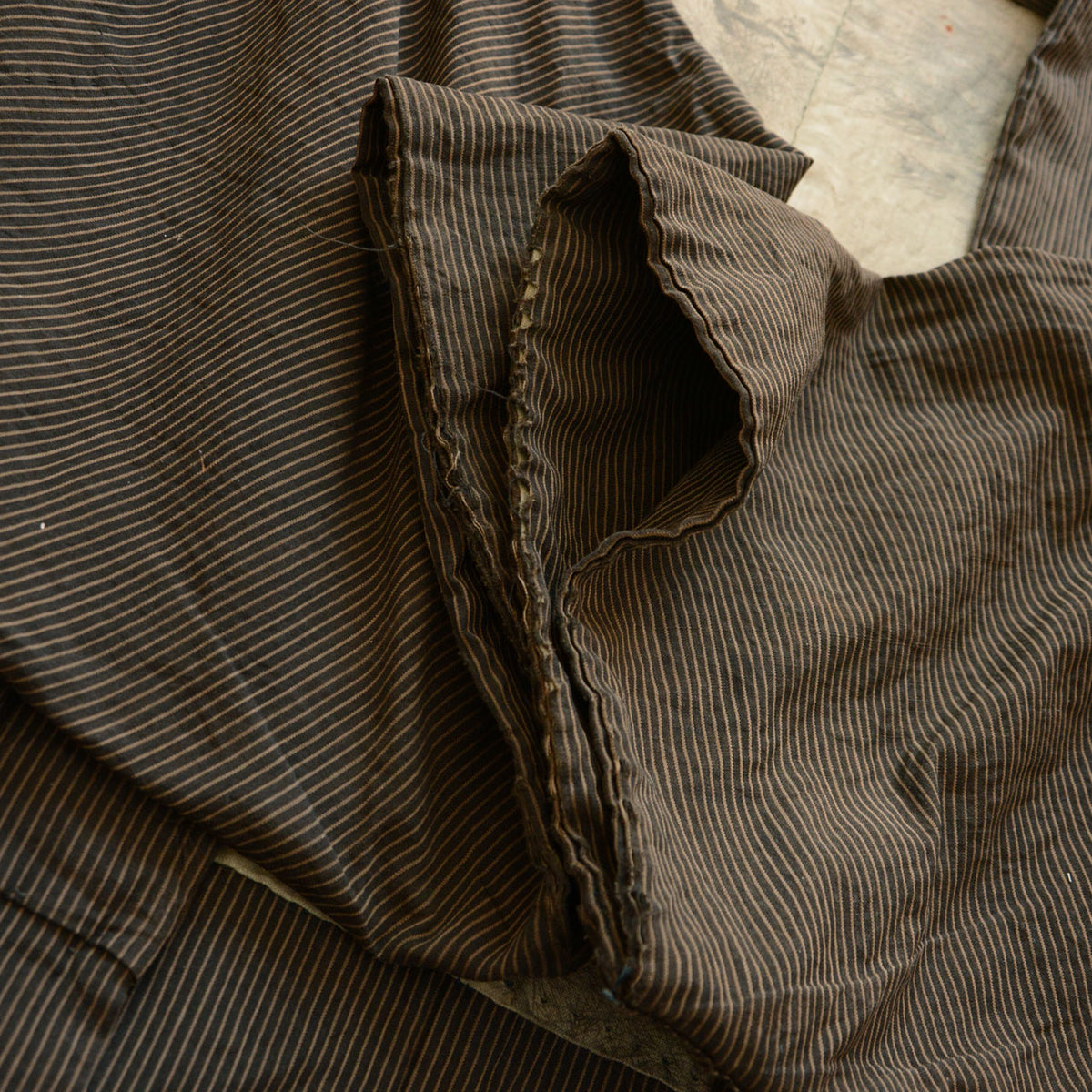 Frayed cuff of the striped cotton sleeve on a Japanese vintage haori jacket