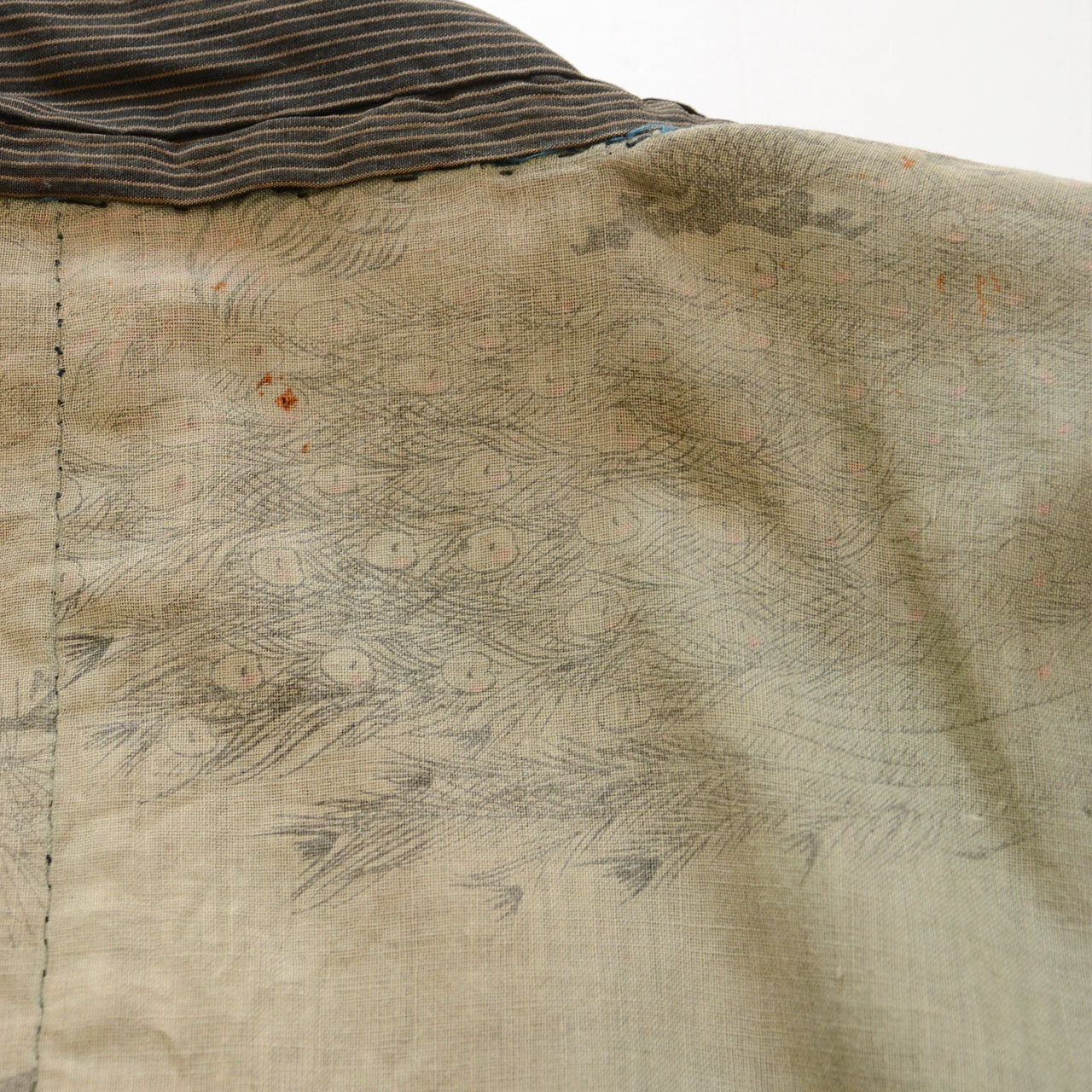 Faded peacock and peacock feather motifs on the lining of a Japanese vintage haori jacket