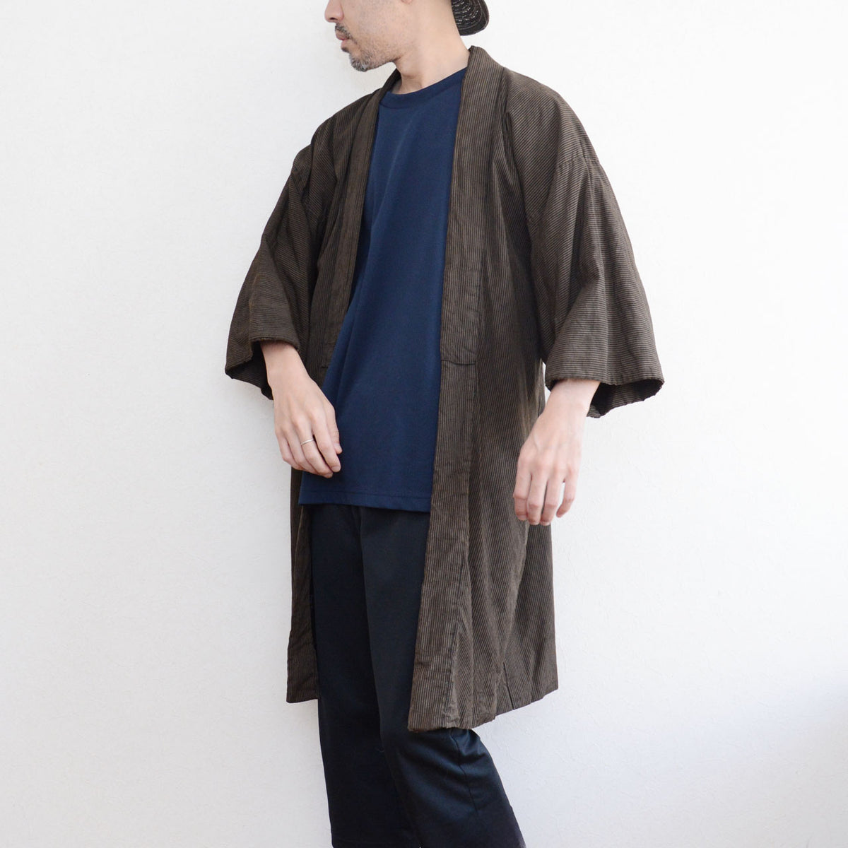 Japanese vintage men's haori jacket worn from a diagonal front view, showing the long silhouette