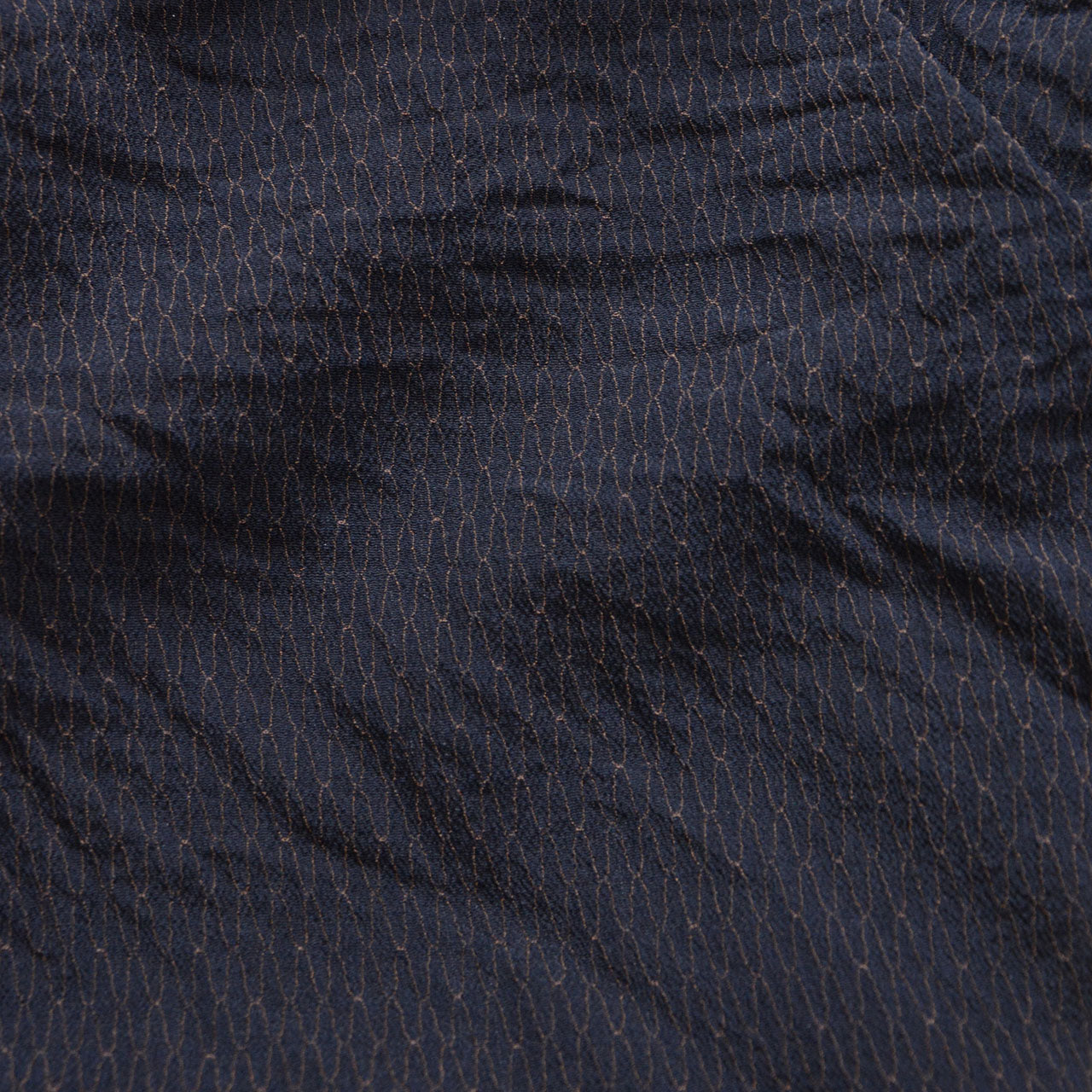 Close-up of the deep navy outer fabric of a Japanese vintage haori kimono jacket with fine wave-like raised texture