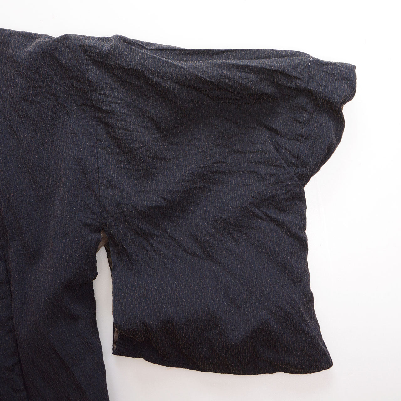 Close-up of the sleeve opening and raised textured outer fabric of a deep navy Japanese vintage haori kimono jacket