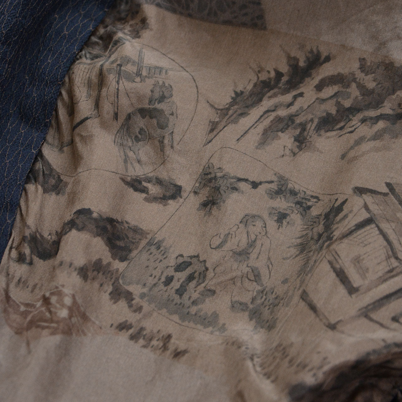 Close-up of Japanese vintage haori lining featuring mountains, trees, figures, and architectural forms