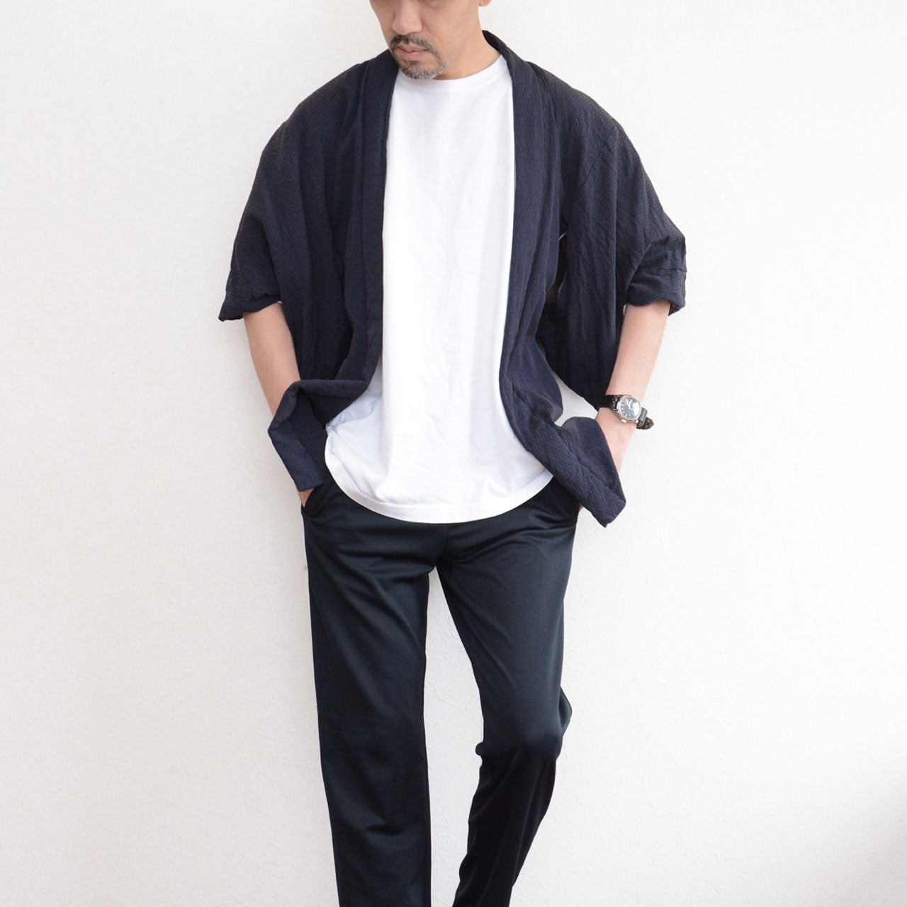 Male model wearing a deep navy Japanese vintage haori kimono jacket over a white T-shirt and black trousers