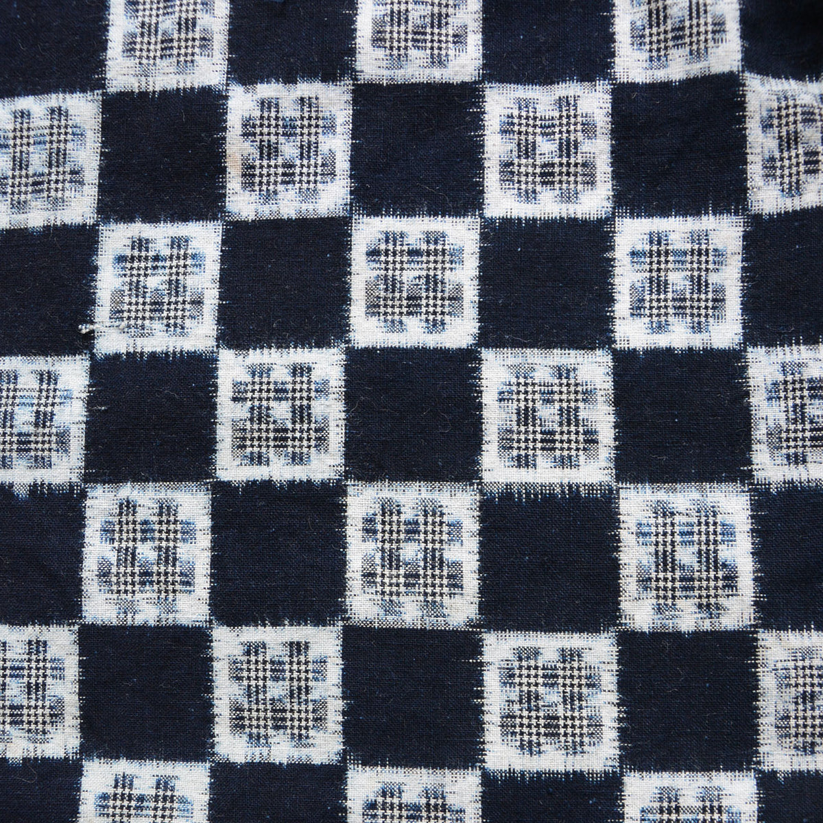 Indigo and white cotton kasuri textile with checkered igeta motif