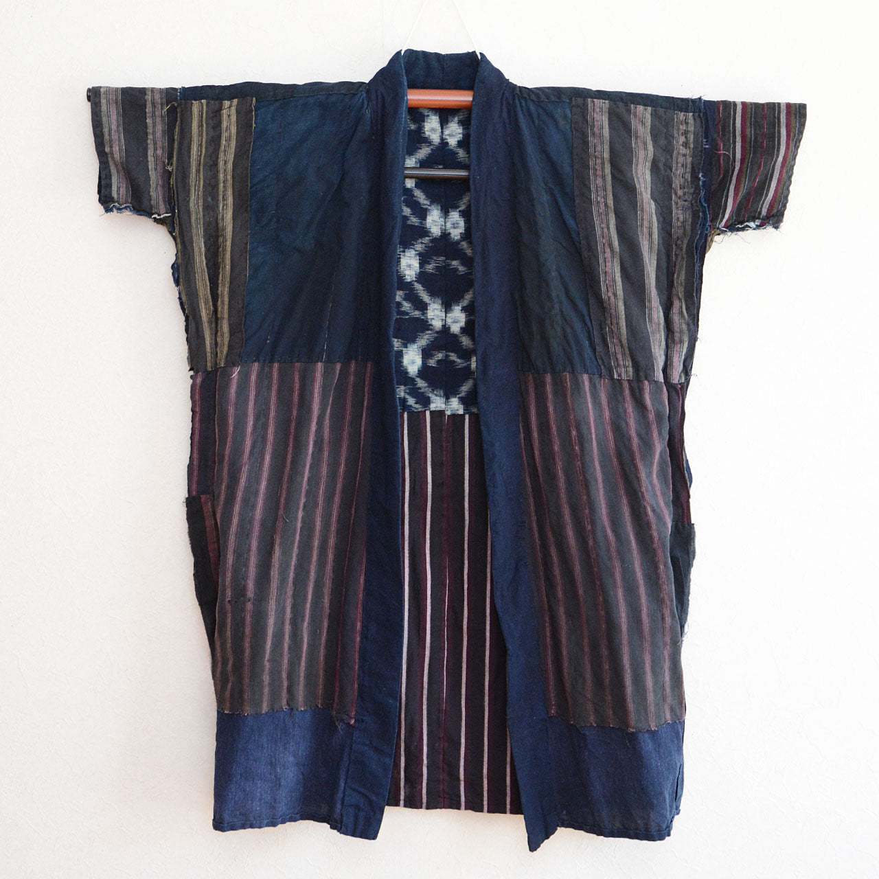 Japanese boro-style work jacket featuring patchwork and visible mending.