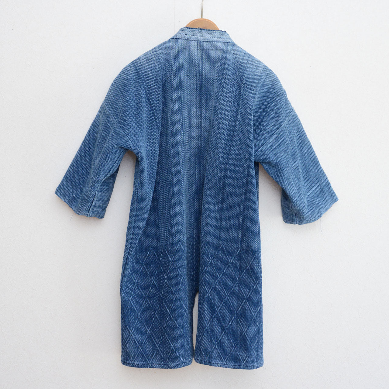 Faded indigo sashiko texture showing years of real use