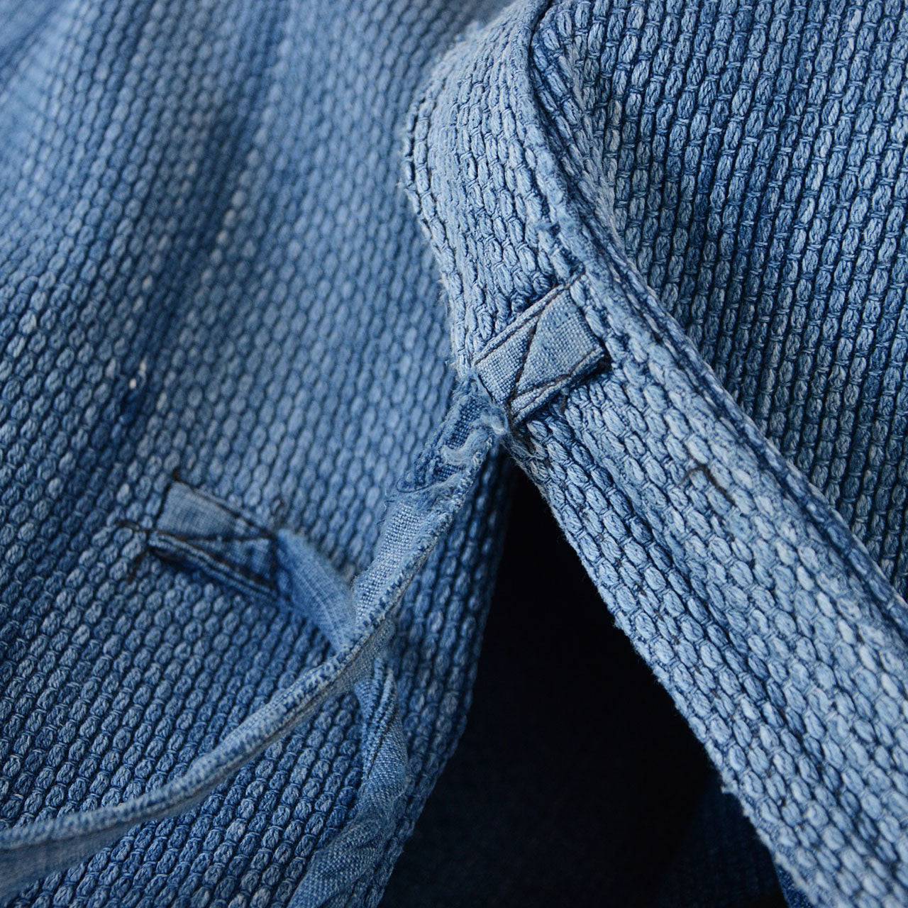 Softly faded indigo tones highlighting the sashiko weave