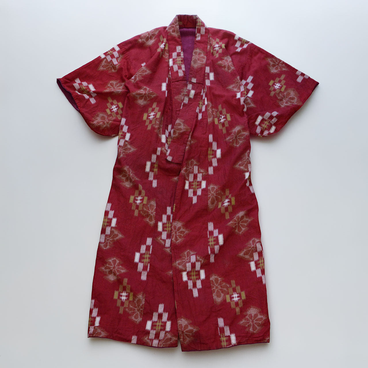 Red-ground cotton kasuri kimono, geometric and floral ikat pattern, Showa era Japan