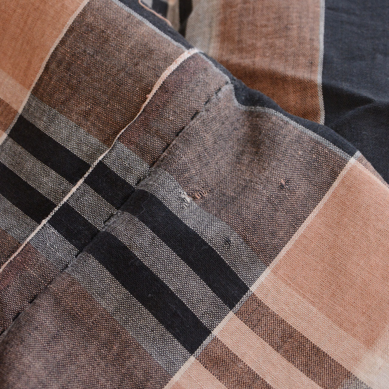 Vintage Japanese cotton check fabric, aged marks and old repairs as part of the fabric's history, black camel plaid, Showa era