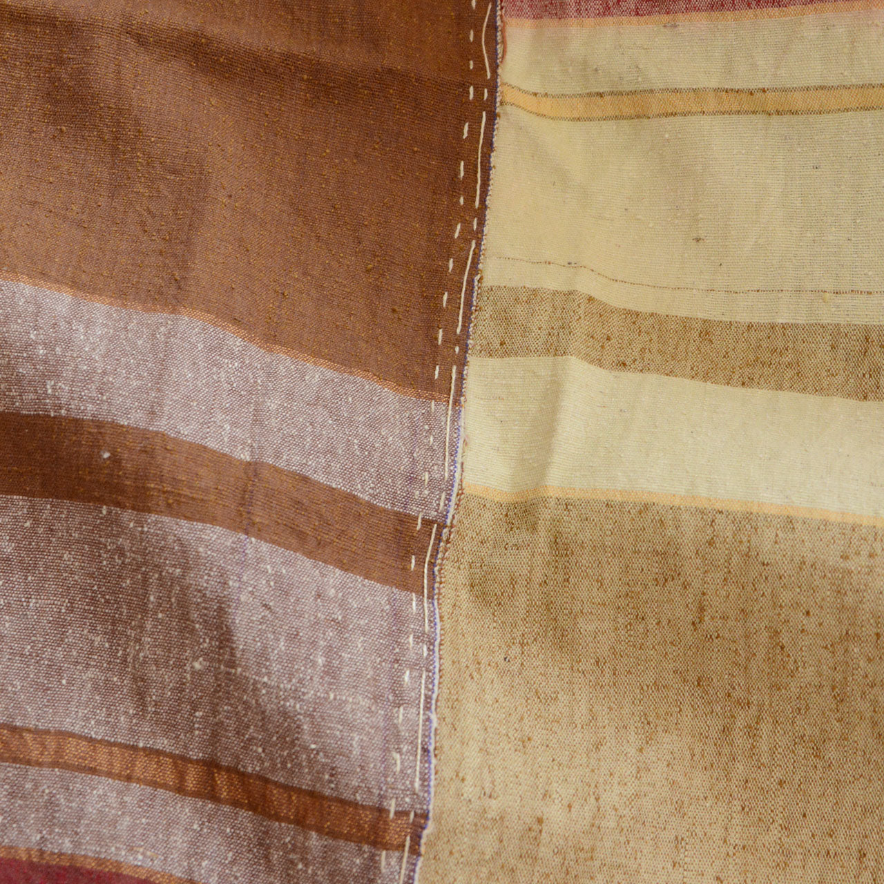 Intricate hand-stitching on vintage Japanese cotton fabric — labor-intensive seam work that had to be done by hand