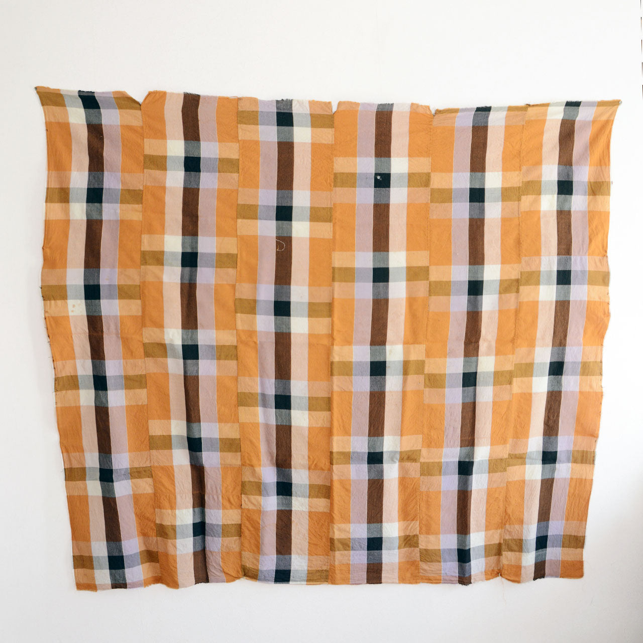 Yellow checkered textile with soft, aged cotton texture
