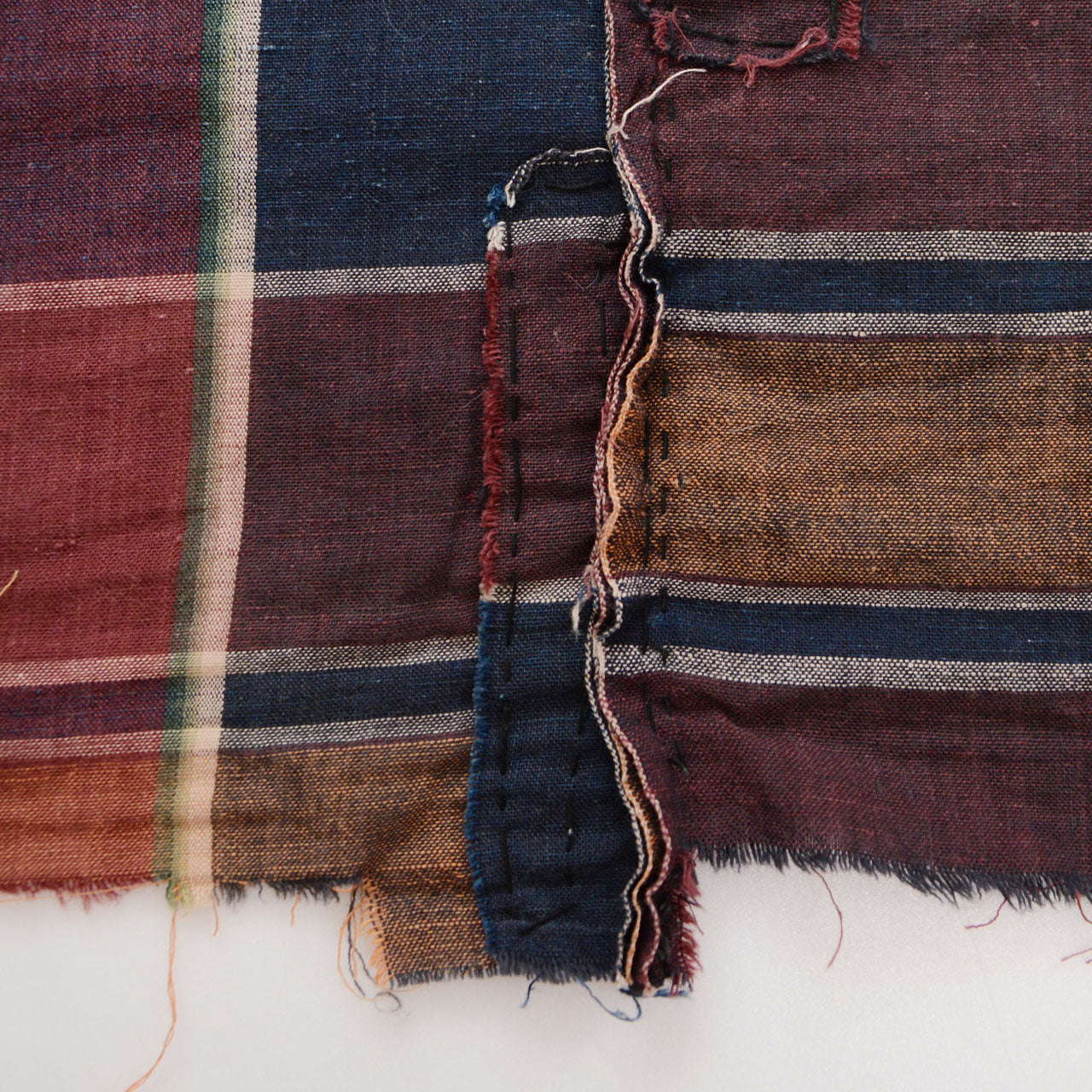 Boro patch repair on vintage Japanese futon cover — hand-applied cotton cloth mending, Showa era textile repair tradition