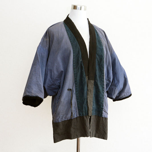 Vintage Japanese workwear jacket with striped pattern and visible repairs