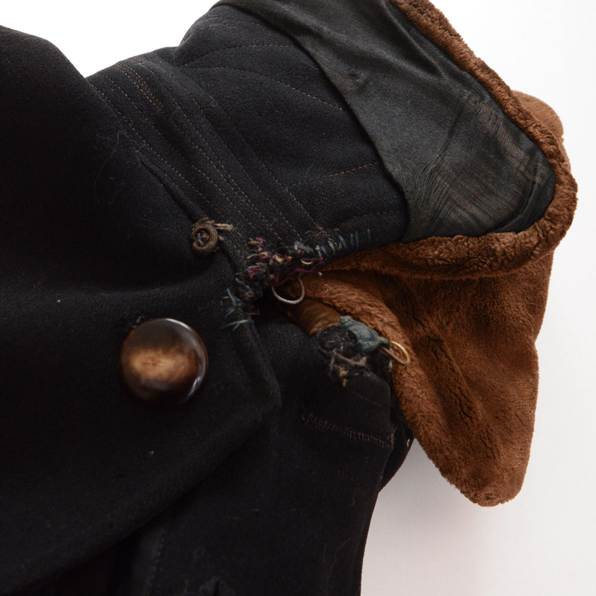 Black wool Bankara mantle showing repairs and damage around the front hooks.
