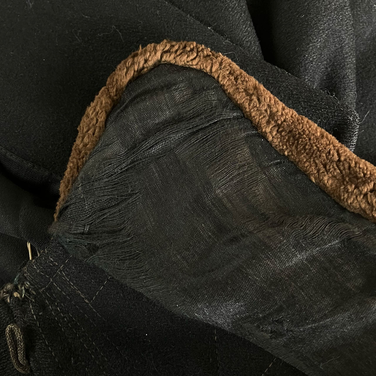Brown fur collar with deteriorated fabric backing on a black wool Bankara mantle.