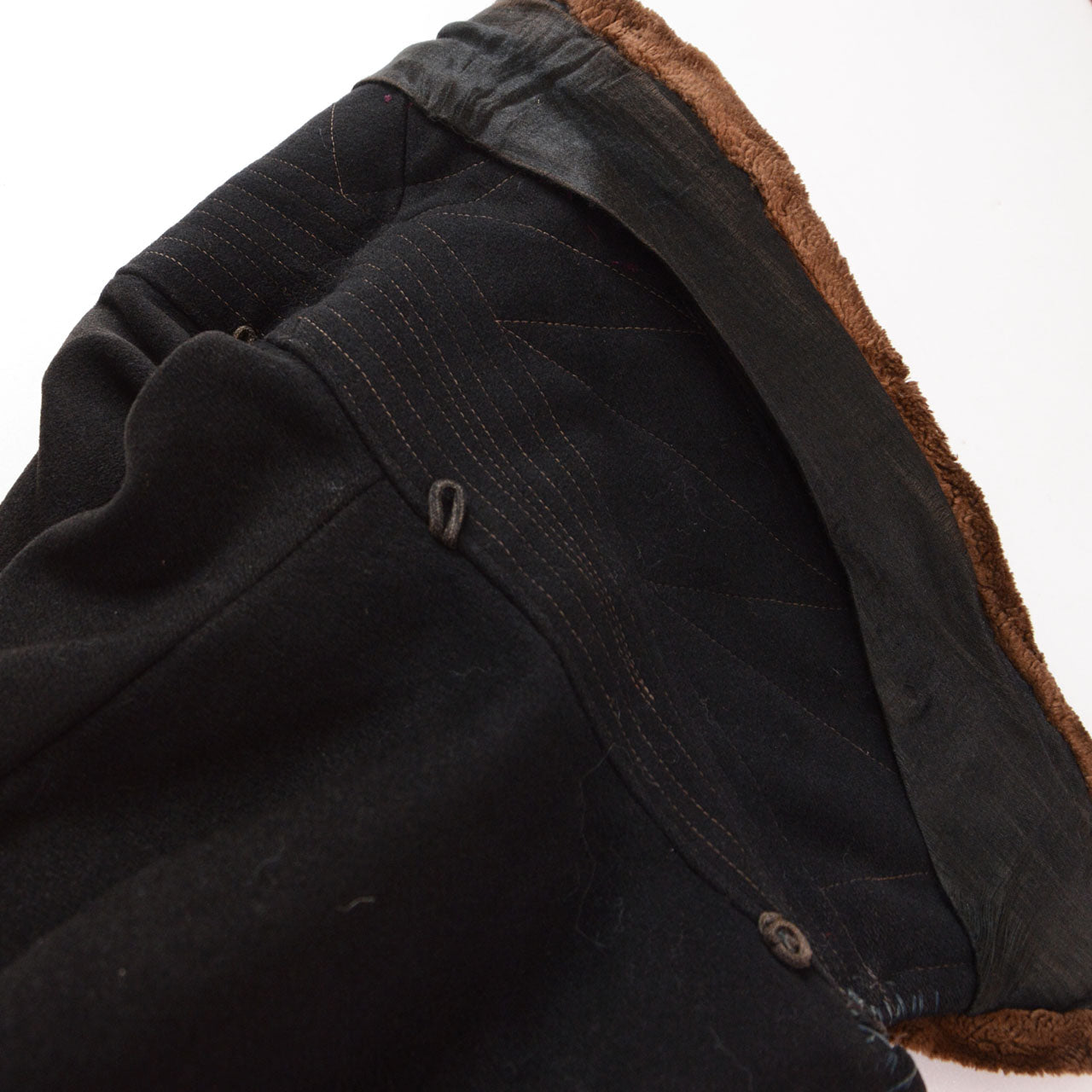 Original black velvet collar with wool underside, machine stitching, and ties for a later hood.