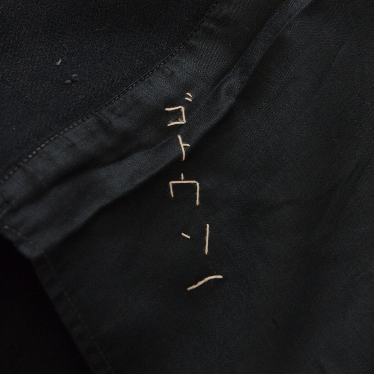 Black lining with a hand-stitched former owner’s name.