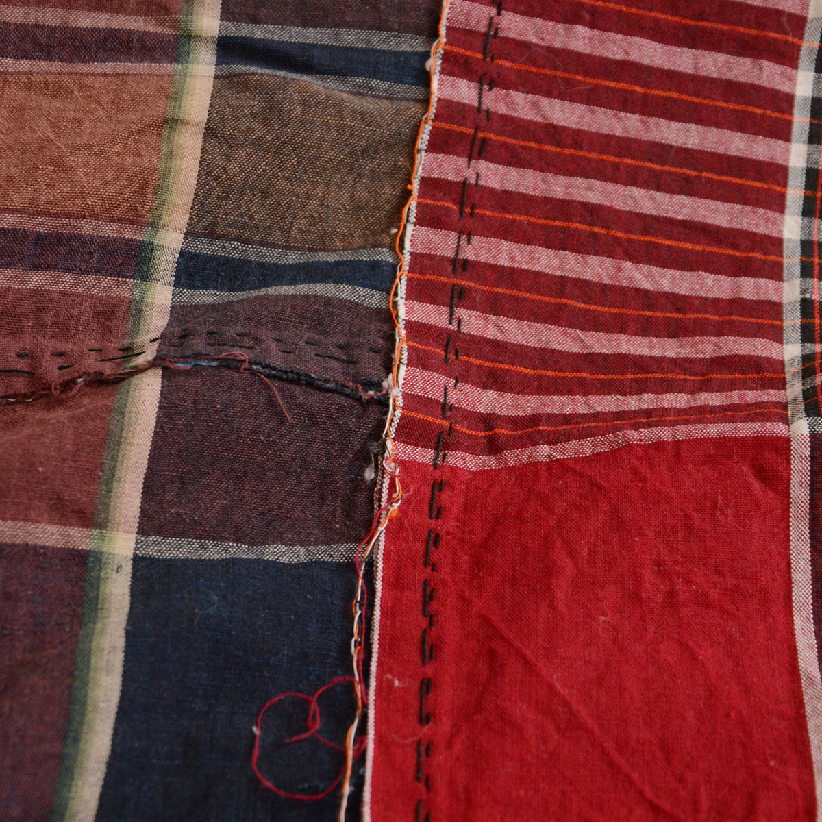 Red striped and indigo checkered Japanese vintage cotton fabric with hand stitching and loose threads
