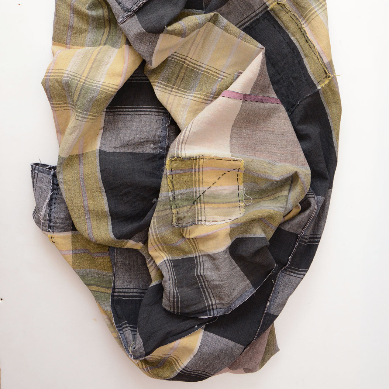 Japanese vintage cotton plaid boro fabric, rolled view showing check pattern and hand-sewn patches, Showa era