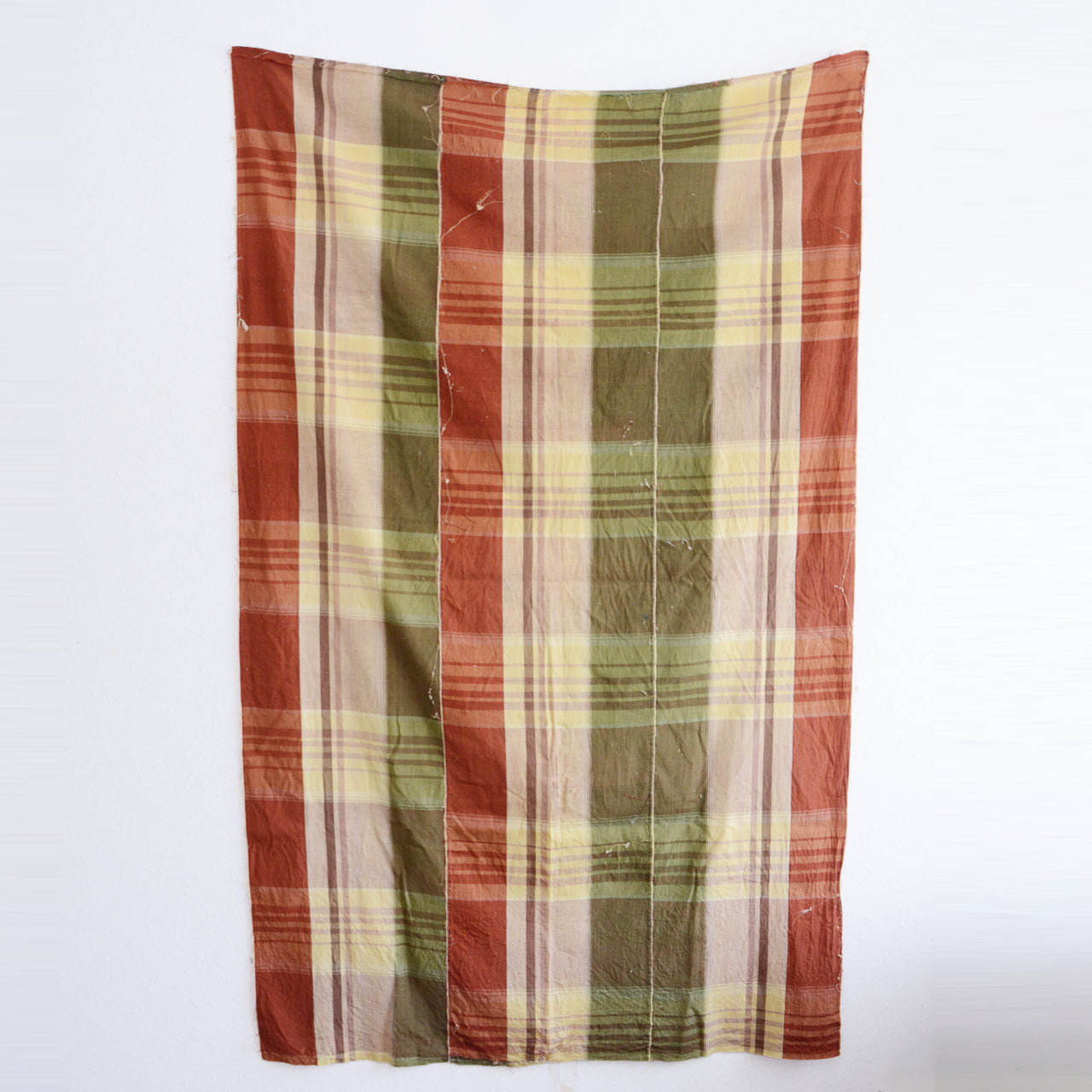 Japanese vintage cotton fabric, rust red plaid with olive green accent, unstitched Showa-era futon textile, raw edges with cotton batting residue and loose threads