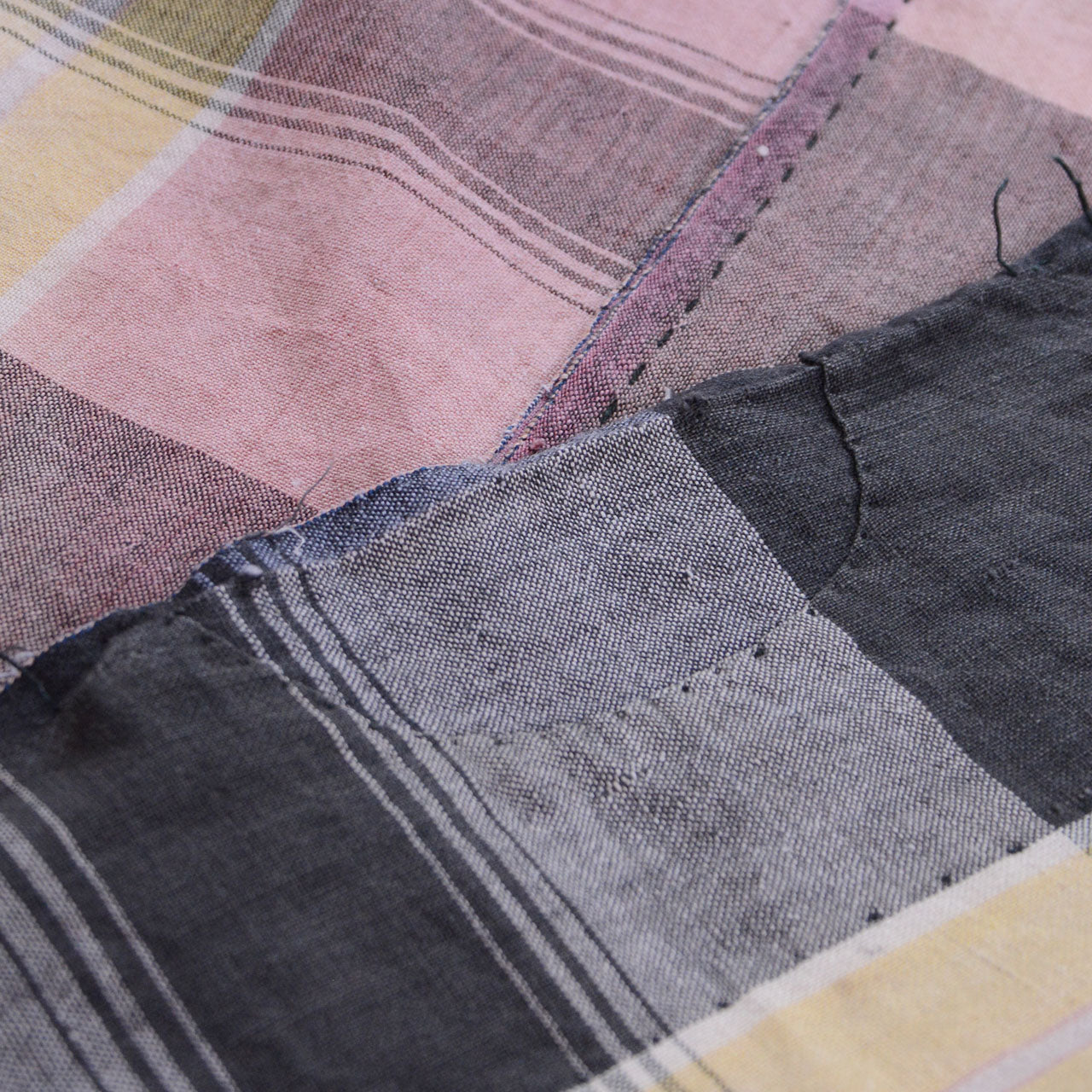 Boro patchwork section on vintage Japanese cotton fabric — layered fabric repairs in the Japanese tradition of mending and reuse