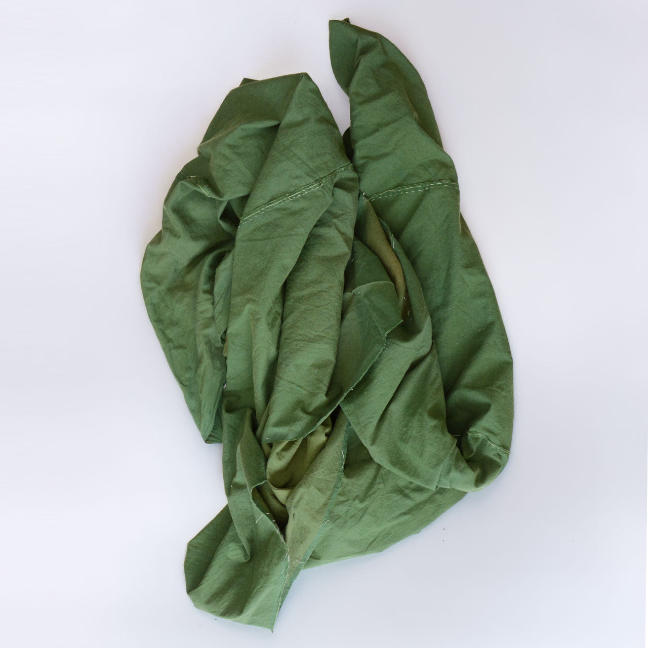 Showa-era Japanese vintage cotton fabric, solid moss green, rolled and gathered, showing natural drape and cotton texture, antique Japanese textile