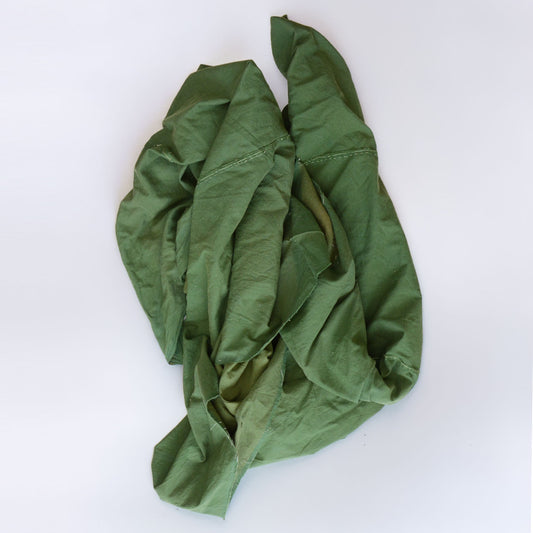 Showa-era Japanese vintage cotton fabric, solid moss green, rolled and gathered, showing natural drape and cotton texture, antique Japanese textile