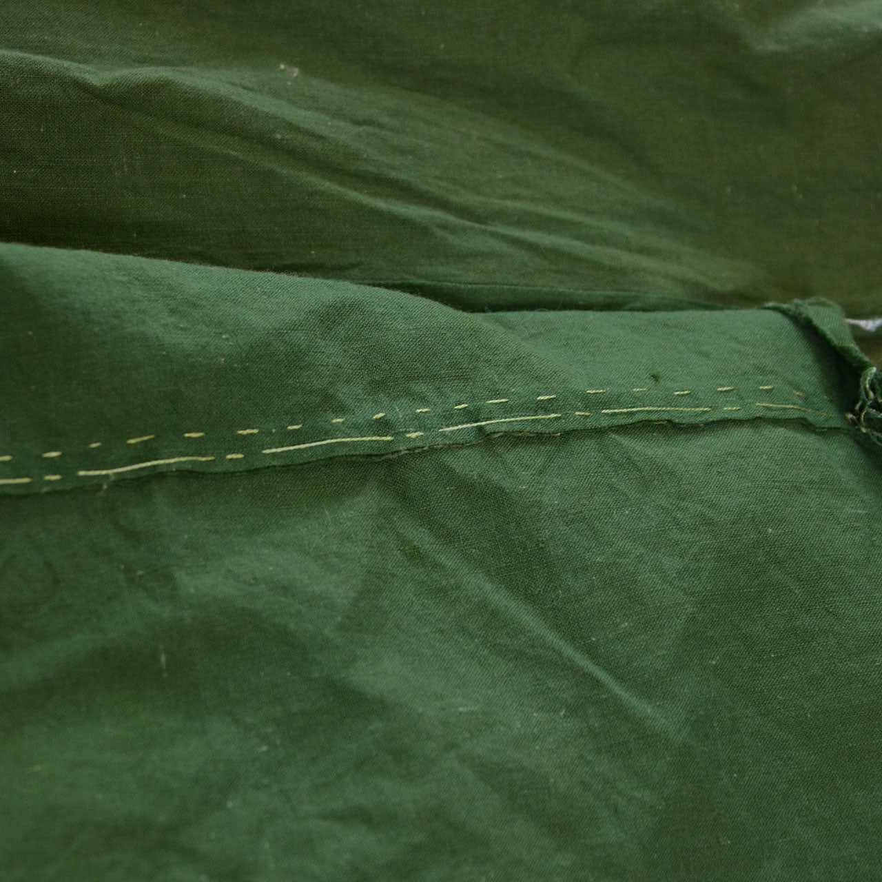 Showa-era Japanese vintage cotton fabric, solid moss green, hand-stitched seam detail, running stitch, panel join, antique Japanese hand sewing