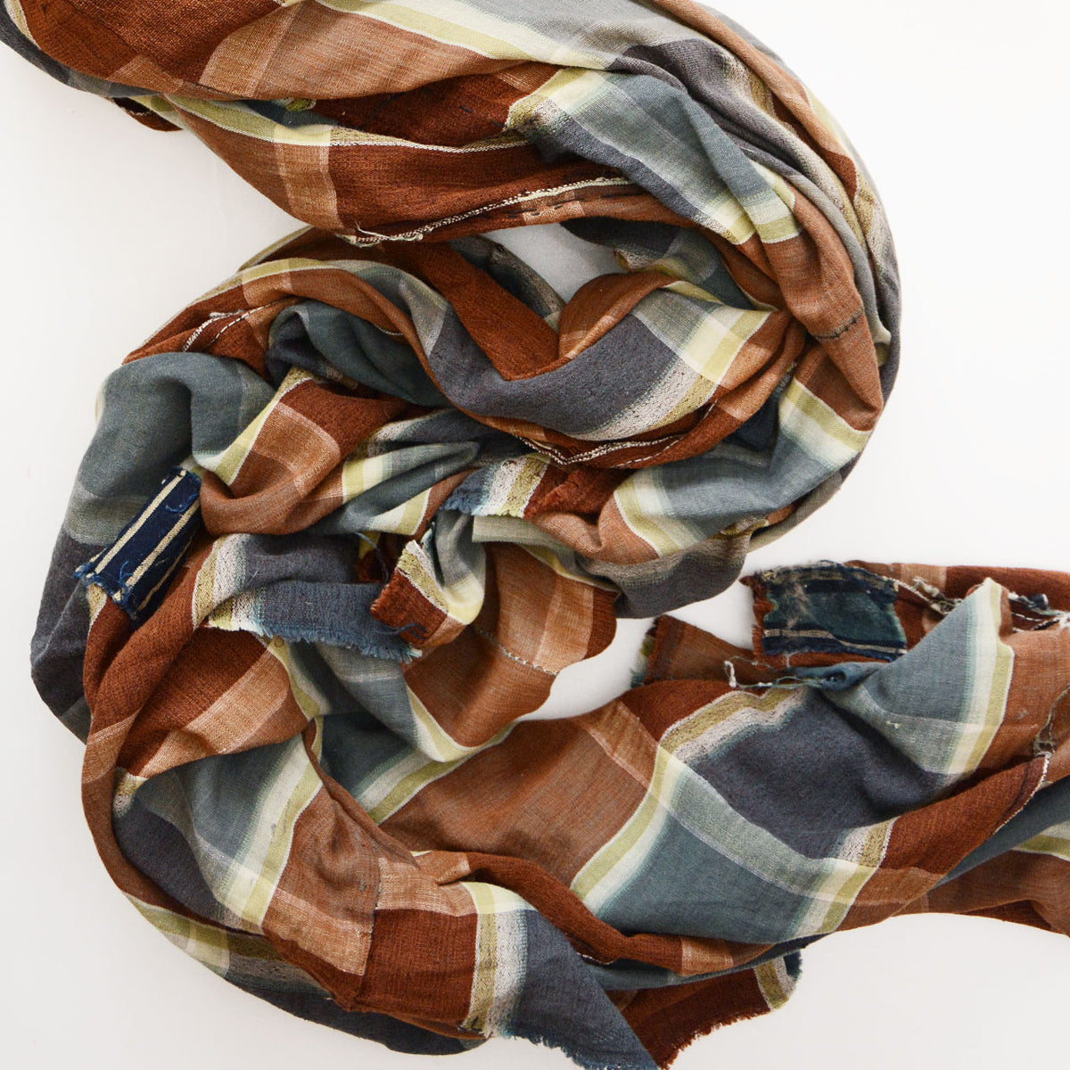 Japanese vintage cotton fabric with a brown, blue-gray, and cream checkered pattern, visible seams and boro repairs