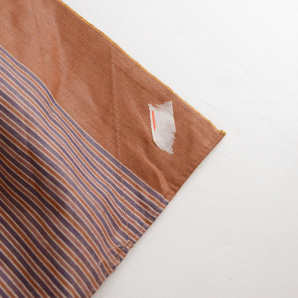 Brown striped cotton furoshiki with a remnant of its original price sticker near the corner