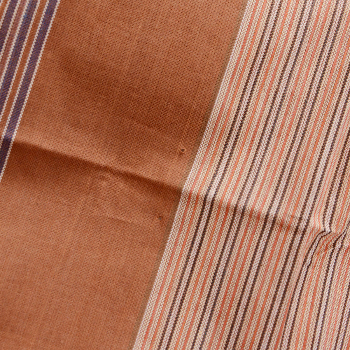 Vintage brown cotton furoshiki with a small hole beside the narrow multicolored stripes