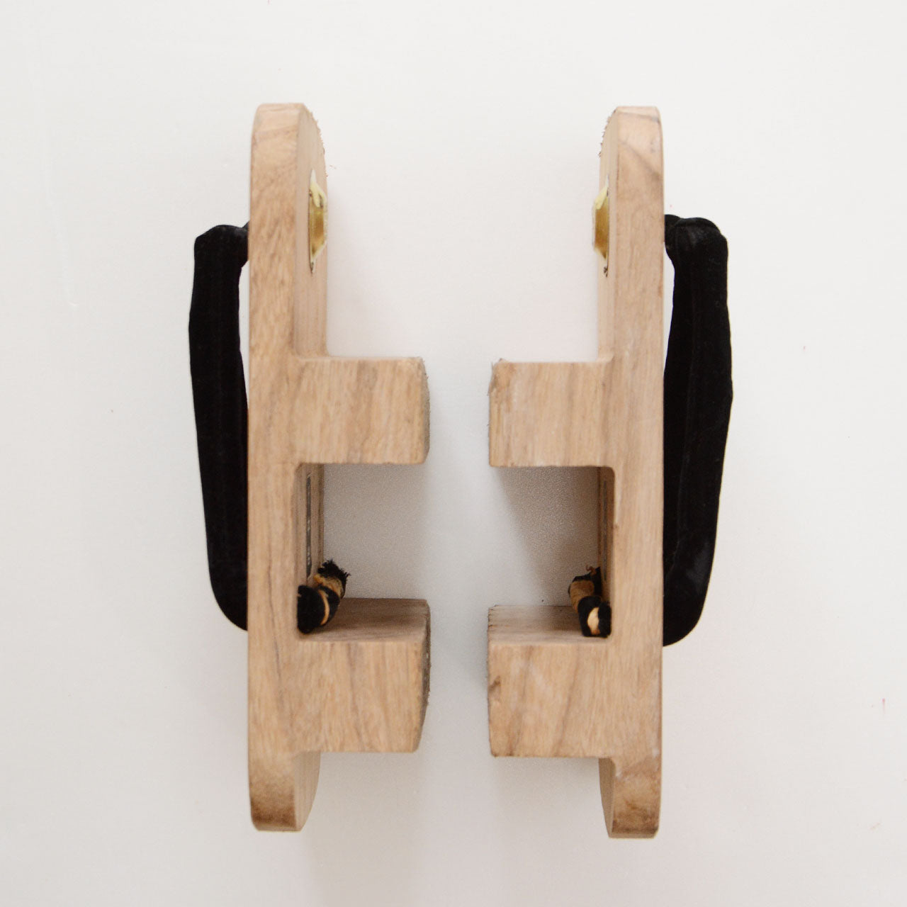 Side view of Aizu Paulownia geta showing two-tooth nimaiba structure and cork-wrapped teeth with natural wood grain