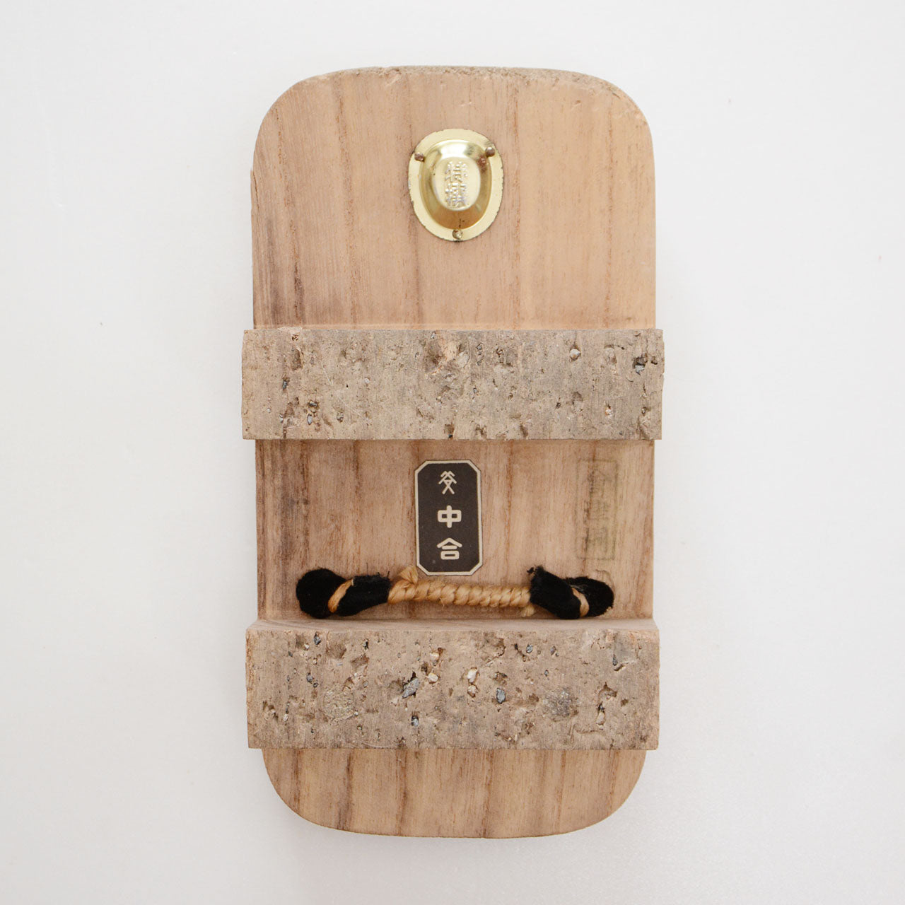 Underside of Aizu Paulownia geta showing cork-covered nimaiba teeth, branded plaques, and knotted hanao base
