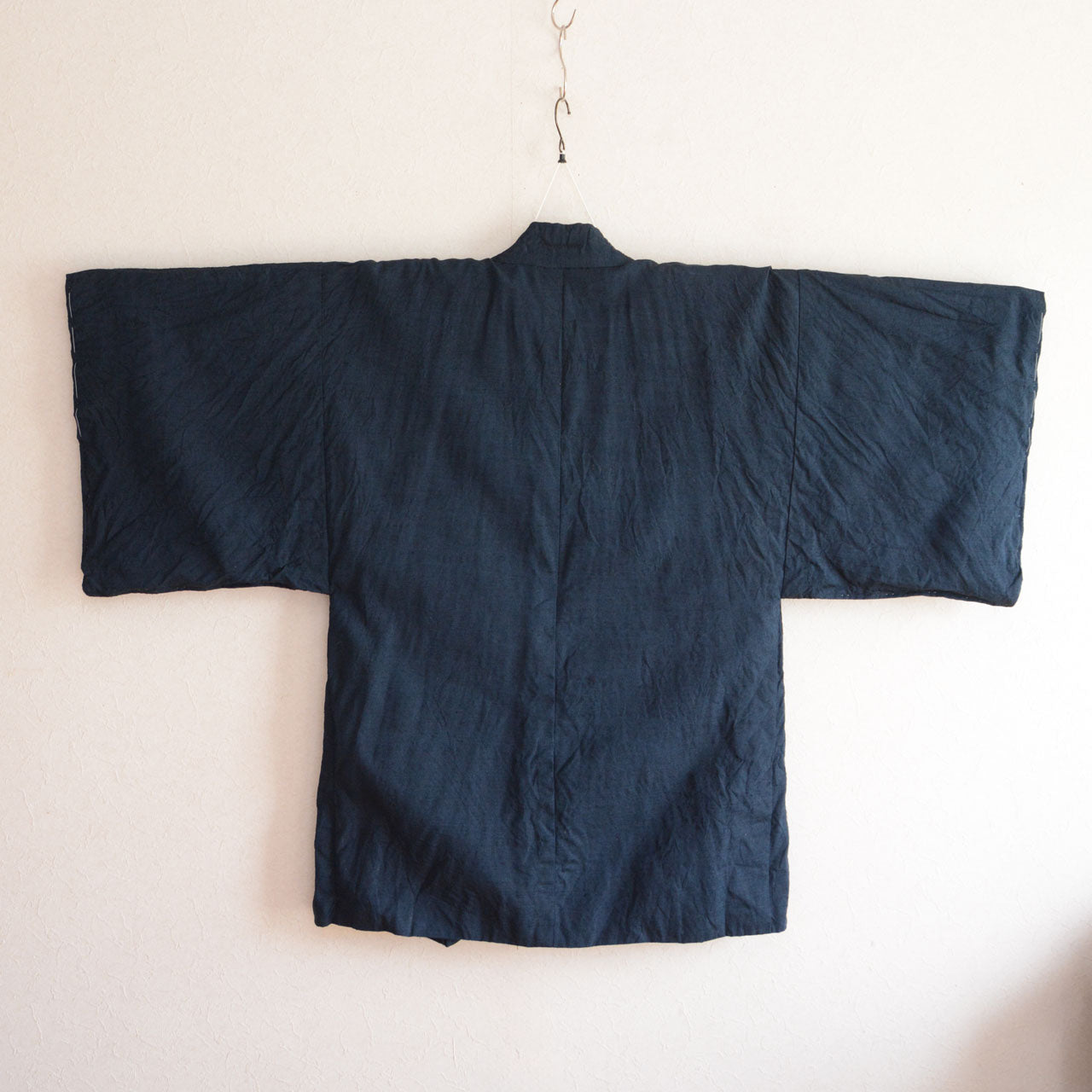 A Japanese haori made with woven fabric depicting a dragon design