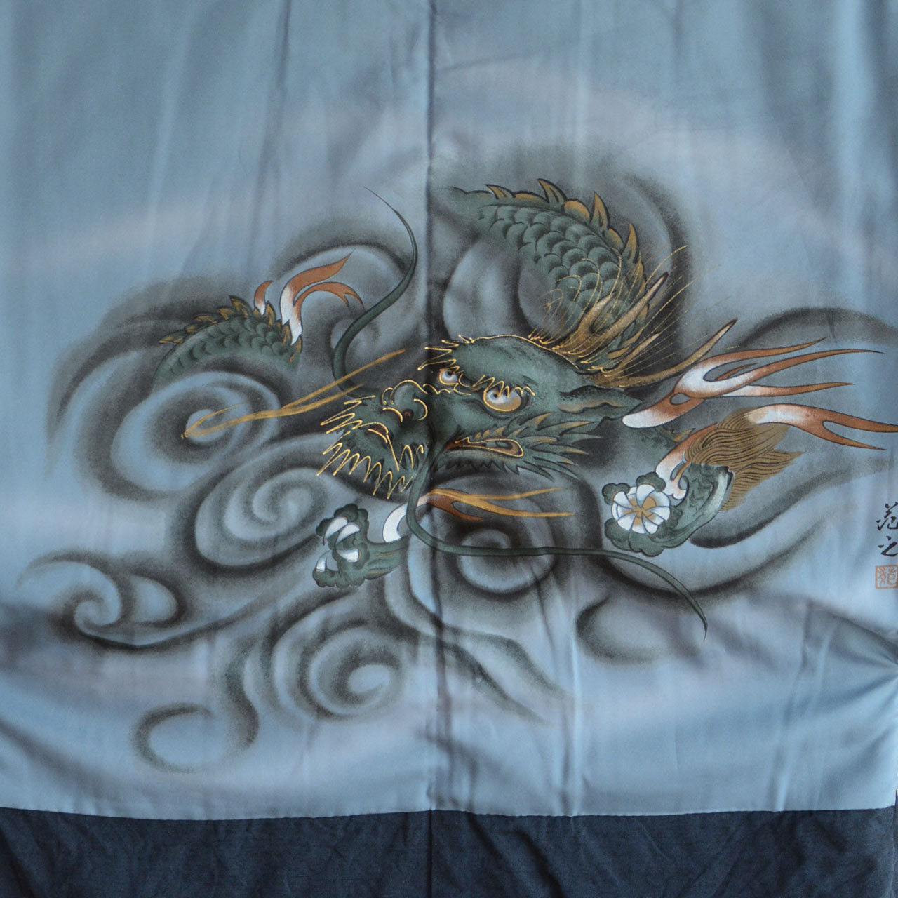 A woven textile garment from Japan featuring a dragon motif
