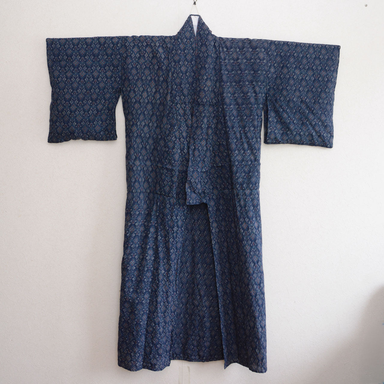 Navy patterned kimono shown with the front panels open and sleeves spread out