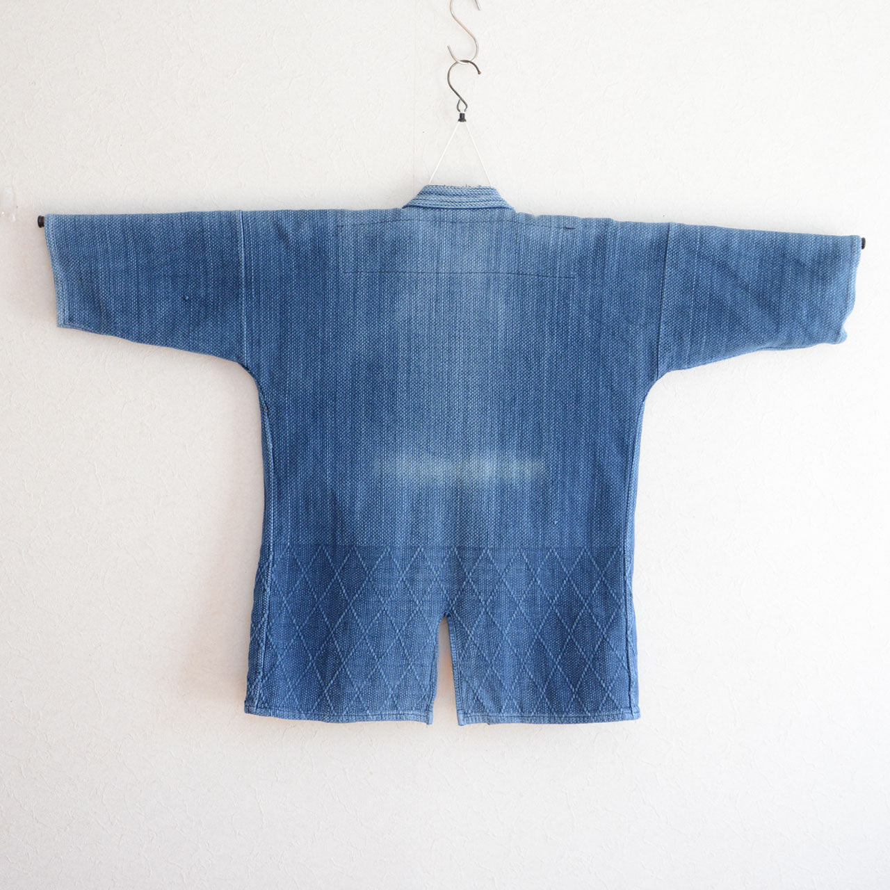 sashiko texture highlighting worn details on indigo jacket